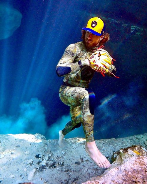 Underwater barefaced redhead in tight wetsuit