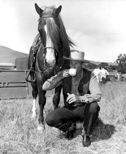 oldhollywoodfilms: John Wayne takes a coffee break on the set of Tall in the Saddle (1944).