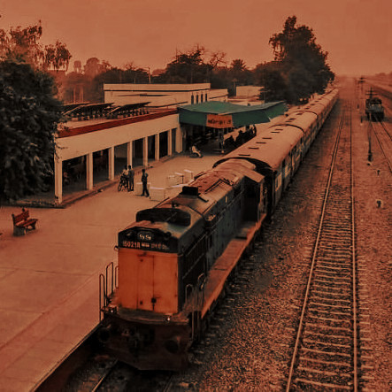 a train pulling up at a rural station in punjab