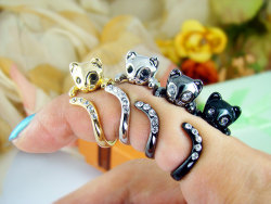 zeiirl:  wickedclothes:  Wraparound Kitty Ring These adorable kitties hug your finger like a real-life pet. Their eyes and tails are accented with Swarovski crystals. Sold on Etsy.  Buh so cute. Black one would match my engagement/wedding right 