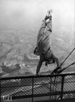 A dapper daredevil balances on a handrail