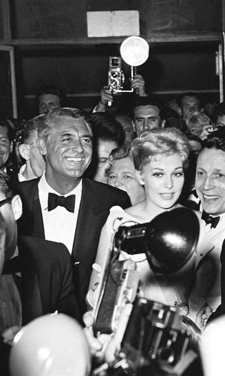 A beaming Cary Grant escorts an anxious Kim Novak at the 1959 Cannes International Film Festival
