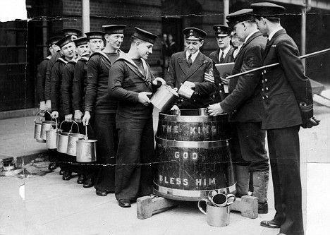 British sailors being issued with rum at the Royal Navy barracks in Portsmouth, England, 1933