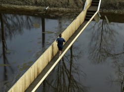 sixpenceee:MOSES BRIDGE, NETHERLANDSIt was originally built in the early 1700’s to protect the Netherlands from invasions. It is constructed out of Accoya wood, a waterproof wood. The designers assured that flooding will not be a problem because the