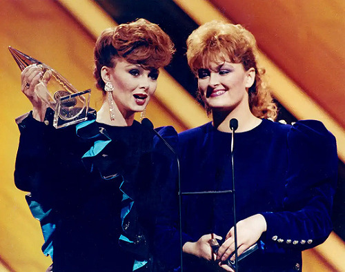 Naomi and Wynonna Judd celebrate their coveted Vocal Group of the Year award over such heavyweights 