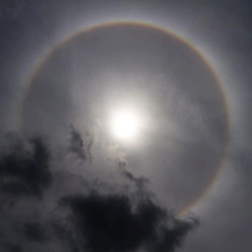 What you are looking at is a “Sun Halo”; or more accurately in this instance, a “22° Halo” taken in 