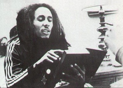 afro-life:  Bob Marley studying some bible scriptures.with ethiopian coptic cross