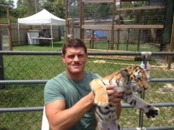 Cody with a baby tiger! I can&rsquo;t handle the cuteness!!! XI