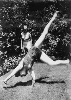 norma-shearer:Norma Shearer doing cartwheels in her garden in Hollywood while friend Merle Oberon looks on, 1936