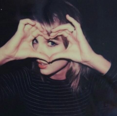 Taylor's hand hearts throughout the eras. —