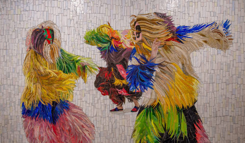 blondebrainpower:  Photos by MTA/Trent Reeves.Spanning the 42 St. Connector between Times Square and Bryant Park in New York City is a troupe of dancing figures dressed in vibrant costumes of feather and fur. The characters are based on the iconic series
