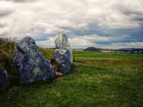 West Kennet Long Barrow and Silbury Hill in the distance, Avebury, Wiltshire.  Perched high on a rid