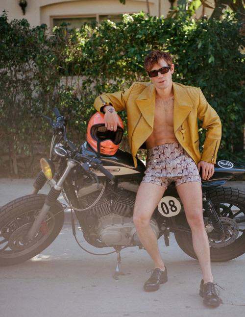 vogueman:KJ Apa photographed by Hadar Pitchon for Behind The Blinds ‘Surrender’ Issue 12 SS2022. KJ wears jacket, shorts, shoes and sunglasses Prada