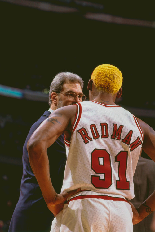 Dennis Rodman photographed by Nathaniel S. Butler while speaking to Phil Jackson during a game again