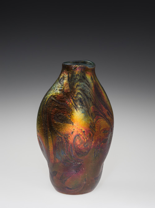  The brilliant red and orange hues of this Favrile “Cypriote” Vase perfectly evoke the changing leav