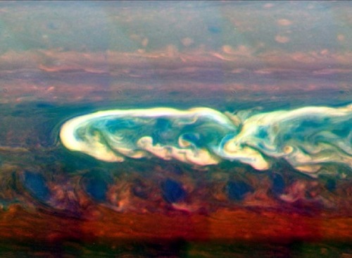 astronomyblog:  Saturn’s atmosphere exhibits a banded pattern similar to Jupiter’s, but Saturn’s bands are much fainter and are much wider near the equator. The nomenclature used to describe these bands is the same as on Jupiter. Saturn’s finer