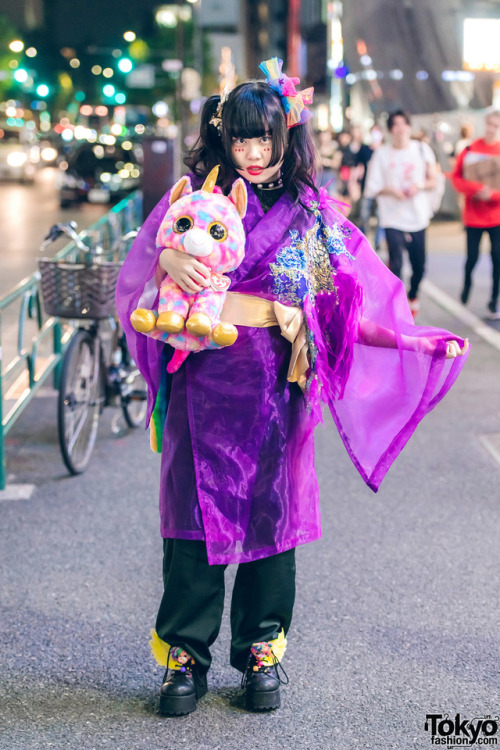 Japanese art student Chami on the street in Harajuku at night wearing a kimono coat from the iconic 