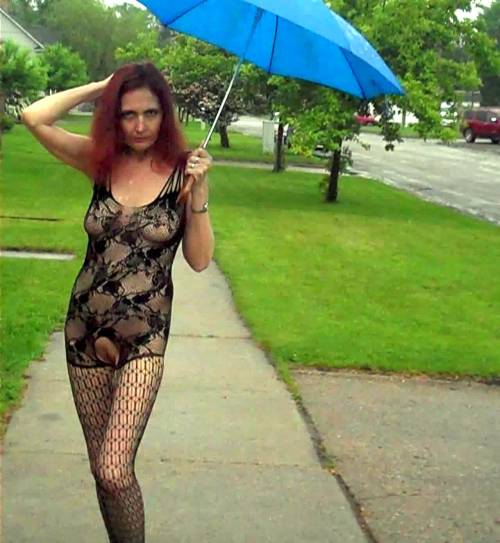 showoffmyslut: Posing in public on a rainy day wearing her new body-stocking (and a couple indoor s