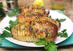 the-exercist:  Hasselback Potatoes from Panning the Globe:   5 large oblong shaped russet potatoes ⅔ cup olive oil 4 tablespoons lemon juice (1 or two lemons) 2 teaspoons dijon mustard (I like Grey Poupon) 2 teaspoons finely chopped garlic ½ teaspoon