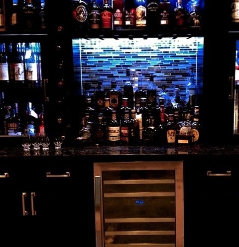 Traditional Home Bar - Home Bar
Ideas for a mid-sized, classic single-wall vinyl floor and multicolored floor home bar remodel with dark wood cabinets, granite countertops, a multicolored backsplash, glass sheet backsplash, and multicolored...