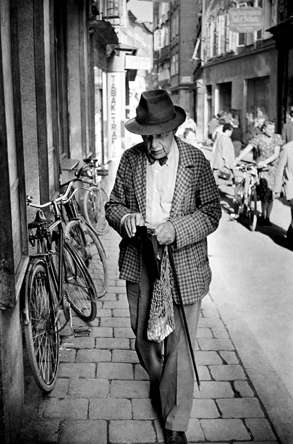 Henri Cartier-Bresson. A man walking in the Getreidegasse of Salzburg, Austria, 1950s