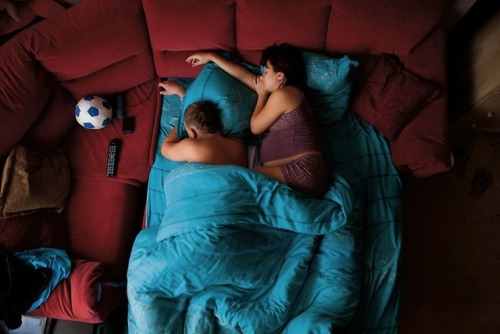  Jana Romanova a Russian photographer captures couples in their sleep to explore their cultural attitude inside their families. Since she didn’t want them to pose she had to stick around their house till they fall asleep deeply and she would take the