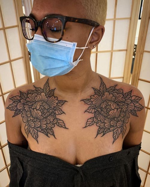 allthepiercingsandbodymods:Chest flower tattoos