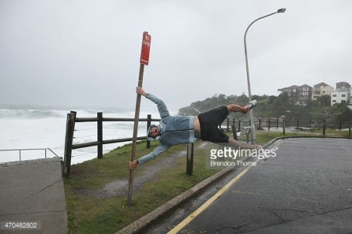 gettyimagesnews: A man held by strong winds poses at Bondi beach on April 21, 2015 in Sydney, Austr