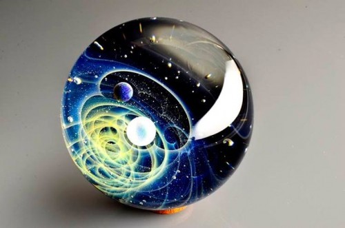 zombies-with-radios:  http://plusalpha-glass.com/index.html  Artist Satoshi Tomizu creates small glass spheres that appear to be miniature solar systems or galaxies, in which planets made of opal are circling into spirals of colored glass and gold flakes.