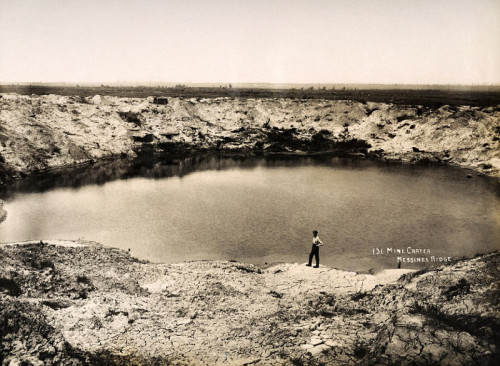 walkingwiththeblackdog:A huge bomb crater at Messines Ridge in Northern France, photographed circa M