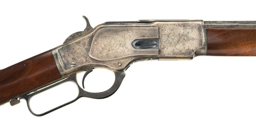 Engraved and silver plated Winchester Model 1873 lever action rifle.