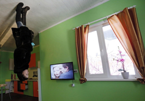 the-gasoline-station:  Upside-down A man passes a house built upside-down in Russia’s Siberian city of Krasnoyarsk. The house was constructed as an attraction for local residents and tourists. Picture: Ilya Naymushin/Reuters