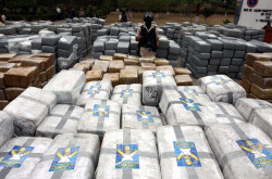 modern-iconoclast:  Mexican security forces stand guard over 105 tons of drugs, wrapped in 10,000 packages – many featuring an image of cartoon character Homer Simpson – in Tijuana in October 2010. 