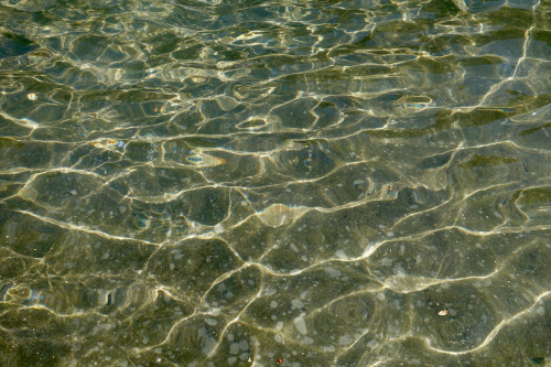 Delineated peaks Afternoon sunlight glints off the surface of the water at the font at Helvetiaplatz