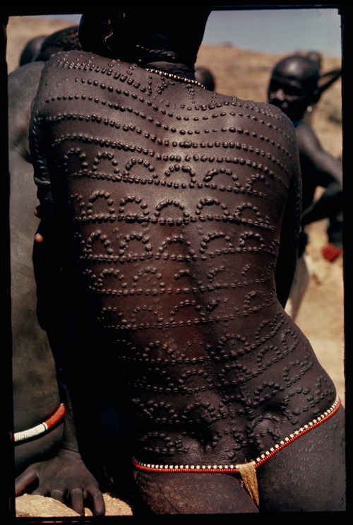 Welts, scars of beauty, pattern the entire back of a Nuba woman in Sudan, 1966. Photograph by Horst 