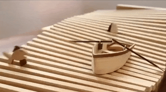 laughingsquid:A Little Boat Floats Among Jumping Fish in a Wonderful Hand-Cranked Wooden Kinetic Wav