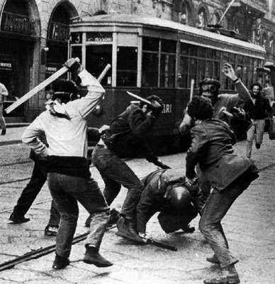 from-around-the-globe:Italian autonomists beat a riot police officer during a ‘banned’ demonstration