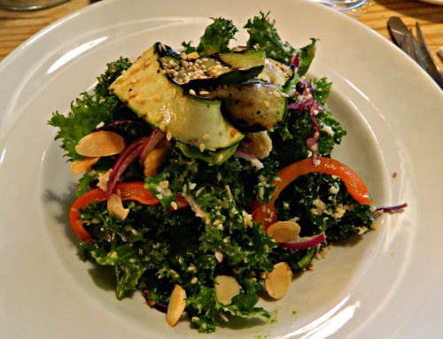 Crazy good kale salad with grilled veggies, slivered almonds, red cabbage, chickpeas, avocado and an
