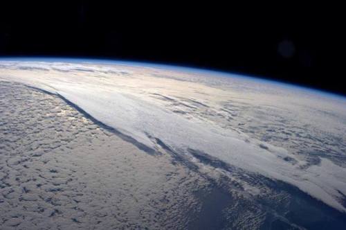 Layered cloudsThe haze of the atmosphere’s edge is glowing blue in the sunlight on the Earth&r