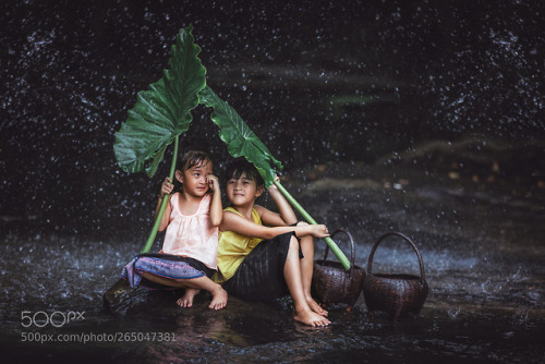 Two Asian beautiful girl plays the water in the river at Thailan