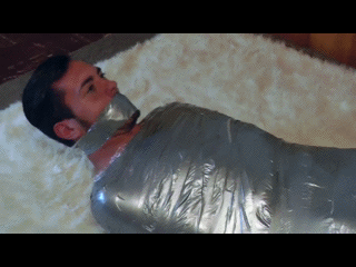 masterboibinder:  MMMMMMPPPPPPHHHH?!?!? Scott was more than a little freaked out when he awakened to find himself nearly fully encased in the restrictive mummifying wrap. He didn’t have much time to process the bizarre circumstances of his abduction