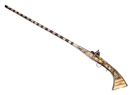 Ornate Moroccan snaphaunce, musket with silver and bone mounts, 19th century.from Helios Auctions