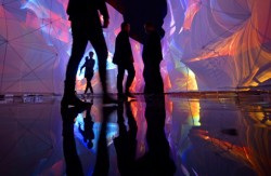 repulsed:  Visitors walk through a light