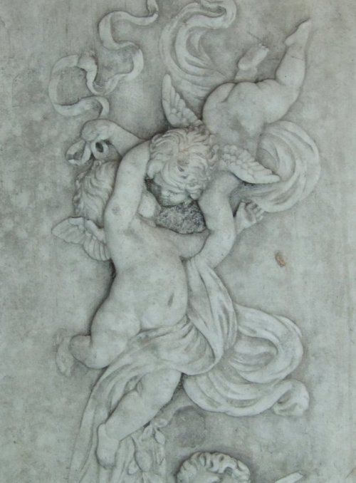 Antique French plaster plaque featuring cascading cherubs, early 1900s.