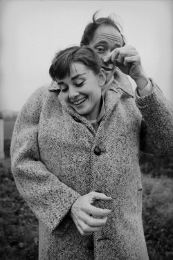 hauntedbystorytelling:    Ed Feingersh :: Close Couple. American actor Mel Ferrer (1917-2008) buttons up his coat around his wife, actress Audrey Hepburn (1929-1993), on a country road outside Paris, 1956. / source: Michael Ochs Archives / Getty Images