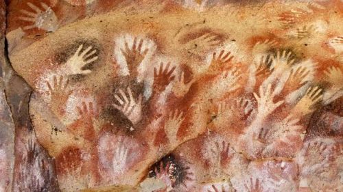 luciferlaughs:Hand prints on the walls of Pettakere Cave in Indonesia. This prehistoric rock art dat