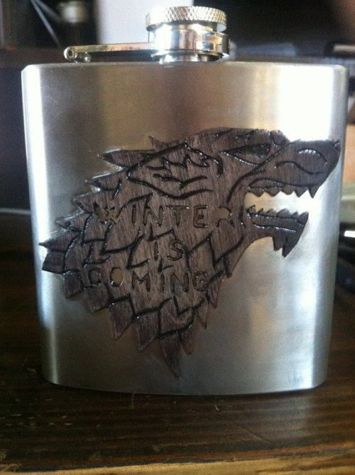 thedrunkenmoogle:  Game of Thrones Carved Flasksby SineCera Represent your favorite house! Steve Barnett has carved the house sigils and words of House Baratheon, Stark, and Lannister onto wood affixed to flasks so that all may know your allegiance. Also