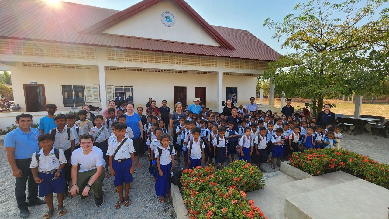 Standing to salute the Cambodian flag at the end of the day.