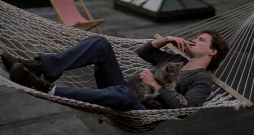 Aidan Quinn cat-lounging in Desperately Seeking Susan