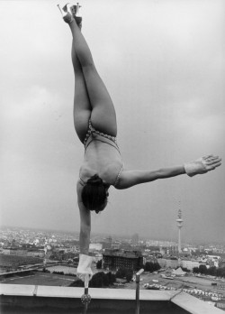 Circus performer Sylvia Teron performing her act on the roof of a skyscraper building in Hamburg, c1950The Impossibles